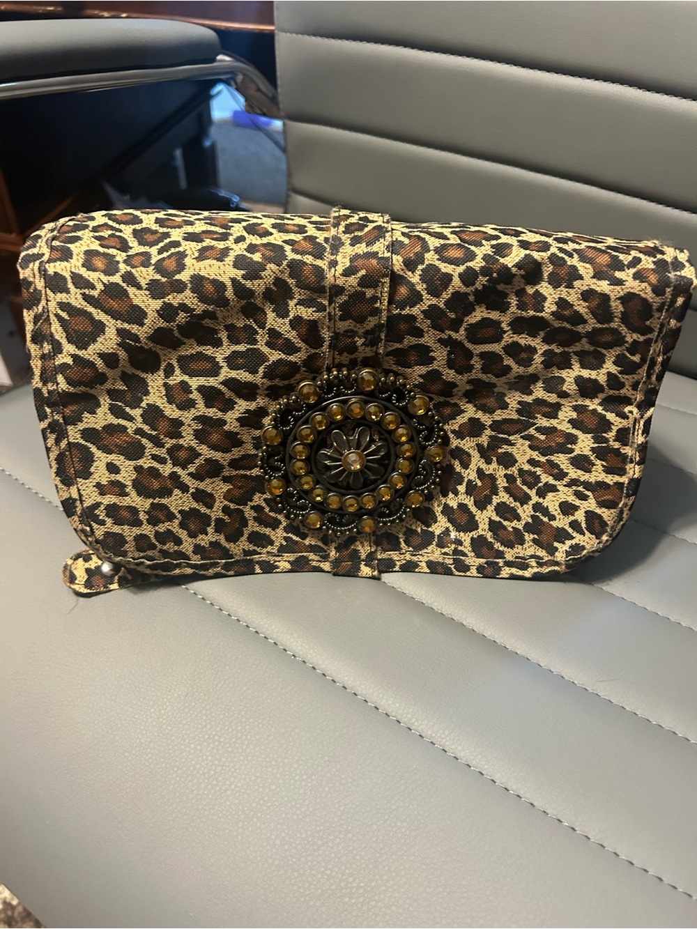 Leopard Print Cosmetic Roll Bag with Decorative Medallion